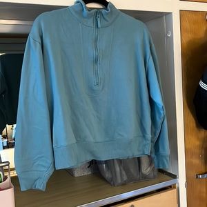 Teal colored half zip sweatshirt